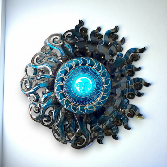 The Talavera Hub Giant Sun Wall Art, handmade metalwork with blue face and swirling rays, includes light fixture.