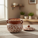 The Talavera Hub brown and white glazed ceramic bean pot with lid, featuring a floral design and dual handles. Holds 128 oz.