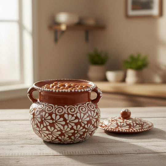 The Talavera Hub brown and white glazed ceramic bean pot with lid, featuring a floral design and dual handles. Holds 128 oz.