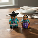 The Talavera Hub hand-painted Guerrero pottery salt and pepper shakers shaped like a couple in traditional Mexican attire.