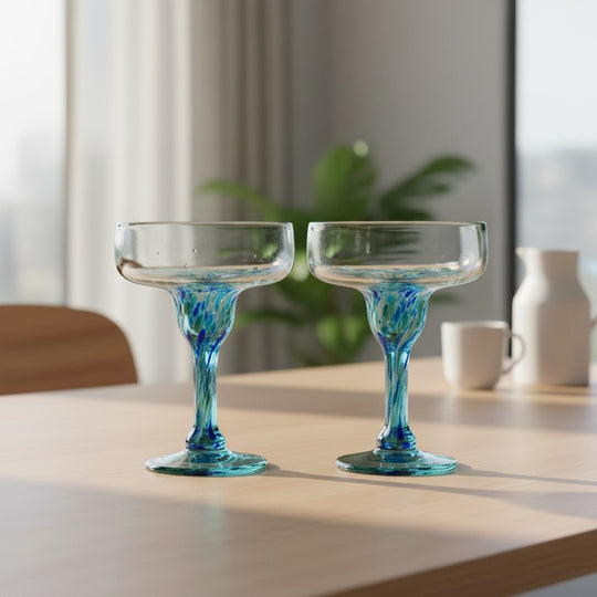 The Talavera Hub hand-blown Mexican margarita glasses with blue and green confetti accents on the stem and base. Clear glass, 16 oz capacity.