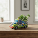 The Talavera Hub hand-painted ceramic car planter in green with colorful floral and geometric designs. Small size, ideal for succulents.