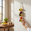 The Talavera Hub hand-painted ceramic fruit garland with apples, oranges, and pears in vibrant colors.