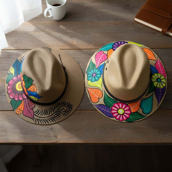 The Talavera Hub hand-painted straw hats with vibrant floral designs. Each sombrero is unique, featuring colorful folk art patterns.