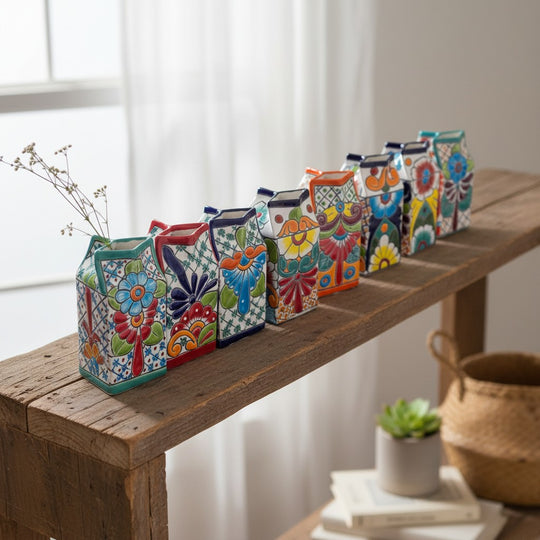 The Talavera Hub hand-painted ceramic milk carton with colorful floral designs and a lead-free glaze.