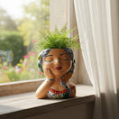 The Talavera Hub hand-painted ceramic lady planter with braided hair, butterfly accent, and traditional attire.