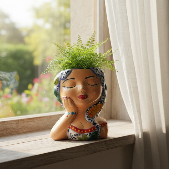 The Talavera Hub hand-painted ceramic lady planter with braided hair, butterfly accent, and traditional attire.