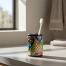 The Talavera Hub handcrafted ceramic toothbrush holder with vibrant hand-painted Mexican folk art and cobalt blue rim.
