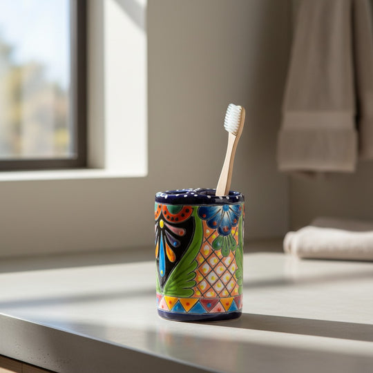 The Talavera Hub handcrafted ceramic toothbrush holder with vibrant hand-painted Mexican folk art and cobalt blue rim.