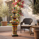 The Talavera Hub 4ft tall handcrafted ceramic fountain, hand-painted with vibrant floral and animal motifs in blue, green, orange, and yellow.