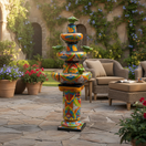 The Talavera Hub 4ft tall handcrafted ceramic fountain, hand-painted with vibrant floral and animal motifs in blue, green, orange, and yellow.