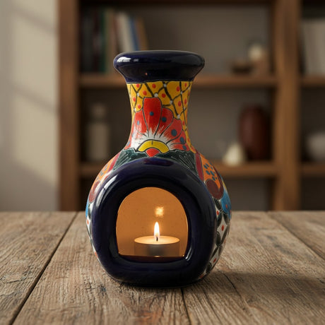 The Talavera Hub handmade Mexican ceramic chimney with vibrant hand-painted floral patterns and a lit tea light candle.
