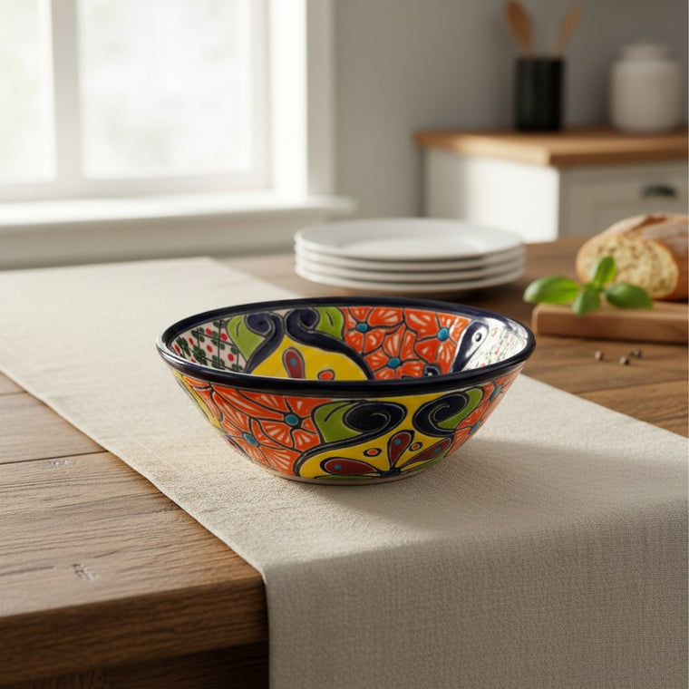 The Talavera Hub handmade 7.5-inch ceramic soup bowl with vibrant hand-painted Mexican floral patterns on a table.