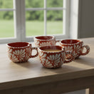 The Talavera Hub hand-painted Mexican heart-shaped mugs with white floral patterns on terracotta ceramic.