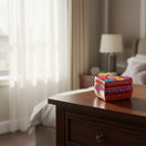 The Talavera Hub heart-shaped ceramic jewelry box with hand-painted floral patterns on a wooden bedroom nightstand.