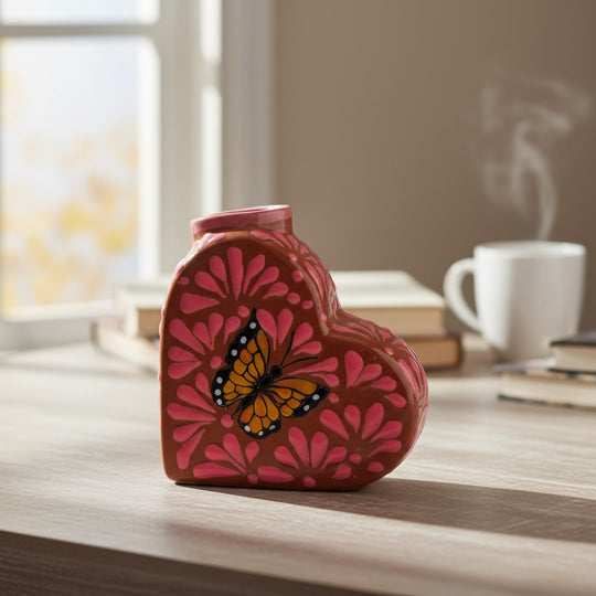 The Talavera Hub heart-shaped ceramic vase with pink floral pattern and monarch butterfly.