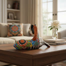 The Talavera Hub hand-painted ceramic horse planter with Day of the Dead floral motifs in vibrant orange, yellow, blue, and red.