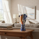 The Talavera Hub Talavera Lady Planter with half face design, ceramic, blue and white floral patterns, red lips.
