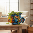 The Talavera Hub large, hand-painted ceramic fish planter in vibrant blue, orange, yellow, and green Talavera style.