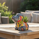 The Talavera Hub medium grey ceramic dog statue with vibrant, hand-painted floral Talavera patterns in red, yellow, blue, and green.