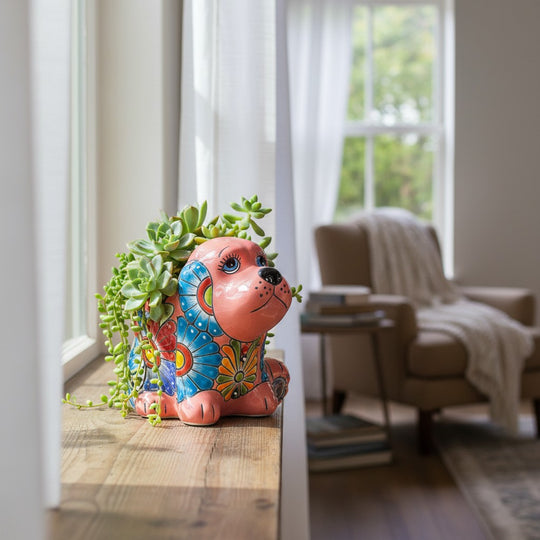 The Talavera Hub medium pink ceramic dog statue with vibrant hand-painted floral blue, green, and red Talavera designs.