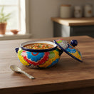 The Talavera Hub handmade ceramic soup pot with lid, hand-painted with vibrant floral designs in yellow, blue, and red.