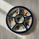 The Talavera Hub colorful ceramic appetizer tray with hand-painted birds and floral motifs. Features 6 sections and a central dish.