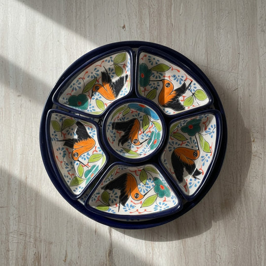 The Talavera Hub colorful ceramic appetizer tray with hand-painted birds and floral motifs. Features 6 sections and a central dish.