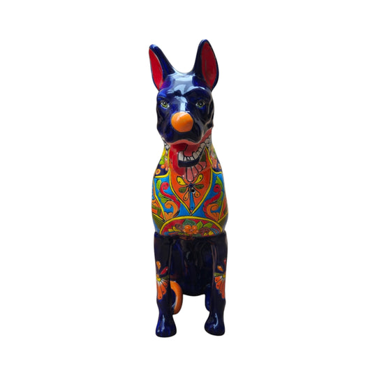 The Talavera Hub handmade Mexican ceramic dog statue with vibrant hand-painted floral patterns and a deep blue base.