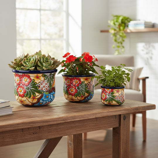 The Talavera Hub set of 3 hand-painted Mexican ceramic flower pots with vibrant floral and geometric folk art patterns.