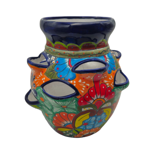 The Talavera Hub hand-painted Mexican ceramic strawberry planter with vibrant floral and geometric patterns.