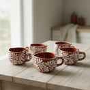 The Talavera Hub hand-painted terracotta mugs with white floral design. Set of 5 Mexican coffee cups.