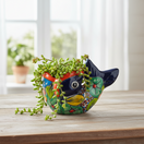 The Talavera Hub hand-painted ceramic fish planter in vibrant red, blue, yellow, and orange with floral motifs.