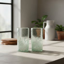 The Talavera Hub hand-blown Mexican highball glass with clear top and white pebble pattern base. Recycled glass.