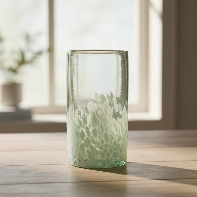 The Talavera Hub hand-blown Mexican highball glass with clear top and white pebble pattern base. Recycled glass.