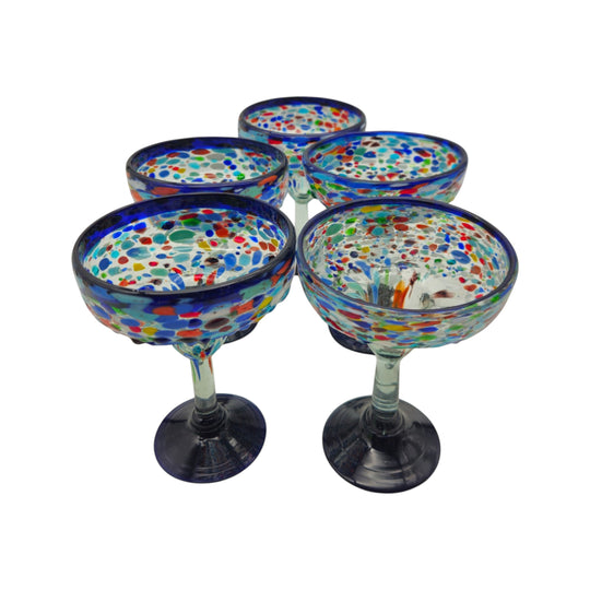 The Talavera Hub hand-blown margarita glasses with blue confetti rock design and cobalt blue rims.