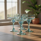 The Talavera Hub hand-blown Mexican margarita glasses with blue and green confetti accents on stem and base. Clear recycled glass, 16 oz capacity.