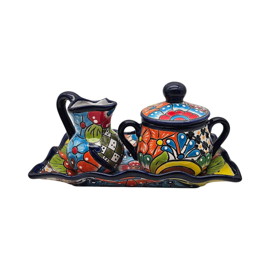 The Talavera Hub 3-piece Mexican pottery coffee set with hand-painted floral patterns in vibrant blue, red, and yellow.