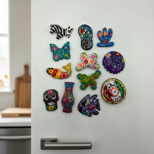 The Talavera Hub assorted hand-painted Guerrero pottery magnets featuring colorful Mexican folk art designs on a fridge