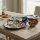 The Talavera Hub 34-piece dinnerware set for 8, featuring hand-painted floral designs in vibrant colors on ceramic.