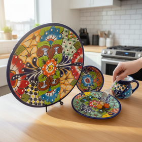 The Talavera Hub 16-piece handmade Mexican Talavera dinnerware set with vibrant floral patterns on ceramic plates, bowls, and mug.