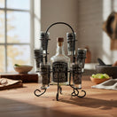The Talavera Hub Mexican Tequila Decanter Set with 6 shot glasses in a black metal holder. Features etched designs.