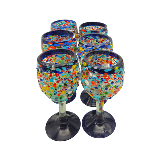 The Talavera Hub hand blown Mexican wine glasses with blue rim and colorful confetti design. Lead-free glass, 12 oz capacity.