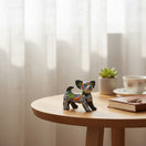 The Talavera Hub Mini Chihuahua Figurine, black with colorful Day of the Dead floral and skeleton motifs.