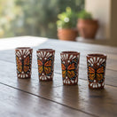 The Talavera Hub handcrafted ceramic shot glasses featuring vibrant orange and black monarch butterfly motifs