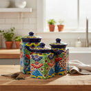 The Talavera Hub 3-piece multicolor ceramic canister set with blue rims and hand-painted floral Mexican patterns.