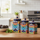 The Talavera Hub 3-piece multicolor ceramic canister set with blue rims and hand-painted floral Mexican patterns.