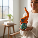 The Talavera Hub orange ceramic elephant statue with hand-painted floral designs and a raised trunk.