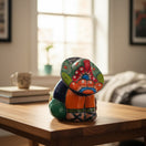 The Talavera Hub handmade Mexican pottery Panchito figurine with vibrant hand-painted floral patterns on a wooden table