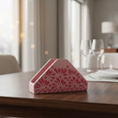 The Talavera Hub pink ceramic napkin holder with a raised pink floral glazed design. Handmade in Mexico.